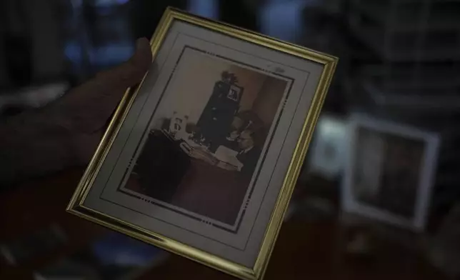 Kamran Afary, an associate professor of communication at California State University, Los Angeles, who immigrated from Iran in the 1970s, shows a photo of his grandfather in his apartment in the "Tehrangeles" neighborhood of Los Angeles, Sunday, June 29, 2025. (AP Photo/Jae C. Hong)