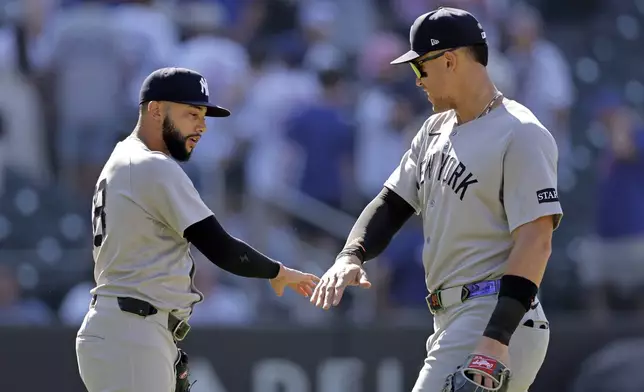 New York Yankees pitcher Devin Williams, left, celebrates with Aaron Judge, right, after they defeated the New York Mets in a baseball game Sunday, July 6, 2025, in New York. (AP Photo/Adam Hunger)