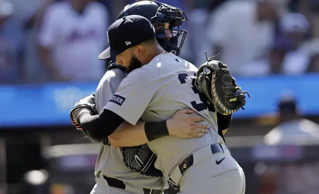 New York Yankees pitcher Devin Williams, front, hugs catcher Austin Wells, back, after they defeated the New York Mets in a baseball game Sunday, July 6, 2025, in New York. (AP Photo/Adam Hunger)