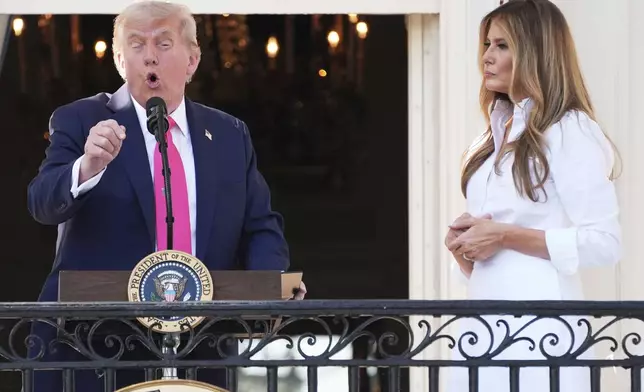President Donald Trump speaks as first lady Melania Trump listens at a picnic for military families at the White House, Friday, July 4, 2025, in Washington. (AP Photo/Evan Vucci)