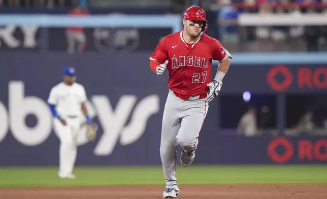 Los Angeles Angels' Mike Trout (27) rounds the bases after hitting a solo home run off Toronto Blue Jays pitcher Kevin Gausman during first-inning baseball game action in Toronto, Sunday, July 6, 2025. (Chris Young/The Canadian Press via AP)