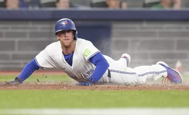 Toronto Blue Jays' Myles Straw scores on an RBI single by teammate Joey Loperfido off Los Angeles Angels pitcher Tyler Anderson during fourth-inning baseball game action in Toronto, Sunday, July 6, 2025. (Chris Young/The Canadian Press via AP)