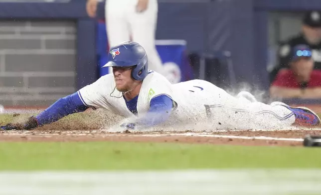 Toronto Blue Jays' Myles Straw scores on an RBI single by teammate Joey Loperfido off Los Angeles Angels pitcher Tyler Anderson during fourth -inning baseball game action in Toronto, Sunday, July 6, 2025. (Chris Young/The Canadian Press via AP)