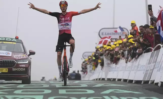 Stage winner Netherlands' Thymen Arensman celebrates when crossing the finish line of the fourteenth stage of the Tour de France cycling race over 182.6 kilometers (113.5 miles) with start in Pau and finish in Luchon Superbagneres, France, Saturday, July 19, 2025. (AP Photo/Mosa'ab Elshamy)