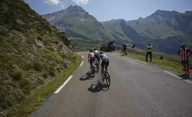 Netherlands' Thymen Arensman, in the lead, is followed by Spain's Carlos Rodriguez and Spain's Pablo Castrillo Zapater as they speed downhill during the twelfth stage of the Tour de France cycling race over 180.6 kilometers (112.2 miles) with start in Auch and finish in Hautacam, France, Thursday, July 17, 2025. (AP Photo/Thibault Camus)