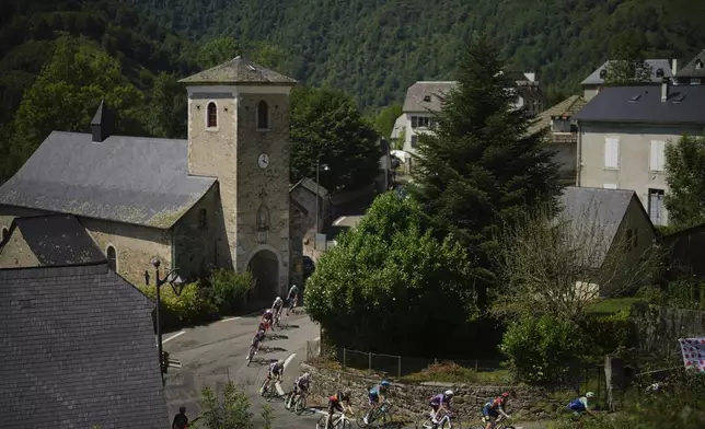 Riders climbs Col du Soulor pass during the twelfth stage of the Tour de France cycling race over 180.6 kilometers (112.2 miles) with start in Auch and finish in Hautacam, France, Thursday, July 17, 2025. (AP Photo/Thibault Camus)
