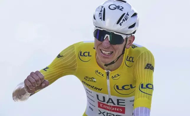 Slovenia's Tadej Pogacar, wearing the overall leader's yellow jersey, celebrates winning the thirteenth stage of the Tour de France cycling race, an individual time-trial over 10.5 kilometers (6.5 miles) in the Pyrenees mountains with start in Loudenvielle and finish in Peyragudes, France, Friday, July 18, 2025. (AP Photo/Thibault Camus)