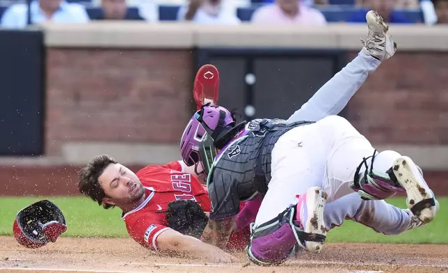 New York Mets catcher Francisco Alvarez, right, tags out Los Angeles Angels' Nolan Schanuel at home plate during the first inning of a baseball game Tuesday, July 22, 2025, in New York. (AP Photo/Frank Franklin II)