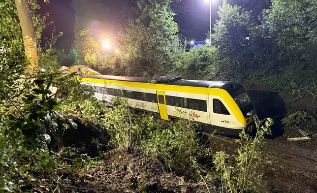 A carriage of the derailed regional passenger train stands on a section of track near Riedlingen, Germany, Sunday, July 27, 2025. (Nico Pointner/dpa via AP)