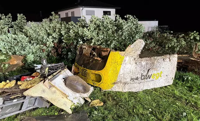 A front section of the derailed regional passenger train lies in a wooded section of track near Riedlingen, Germany, Sunday, July 27, 2025. (Nico Pointner/dpa via AP)