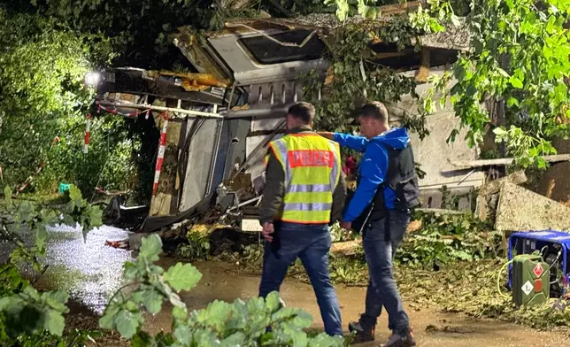 Parts of the derailed regional passenger train lie next to a section of track near Riedlingen, Germany, Sunday, July 27, 2025. (Nico Pointner/dpa via AP)
