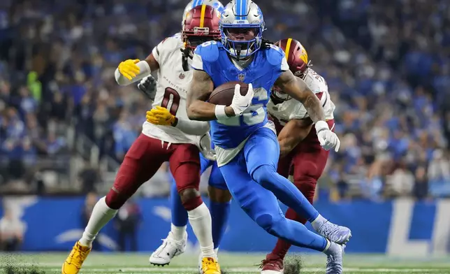 FILE - Detroit Lions running back Jahmyr Gibbs (26) runs past Washington Commanders cornerback Mike Sainristil (0) during the first half of an NFL football divisional playoff game, Saturday, Jan. 18, 2025, in Detroit. (AP Photo/Rey Del Rio, File)