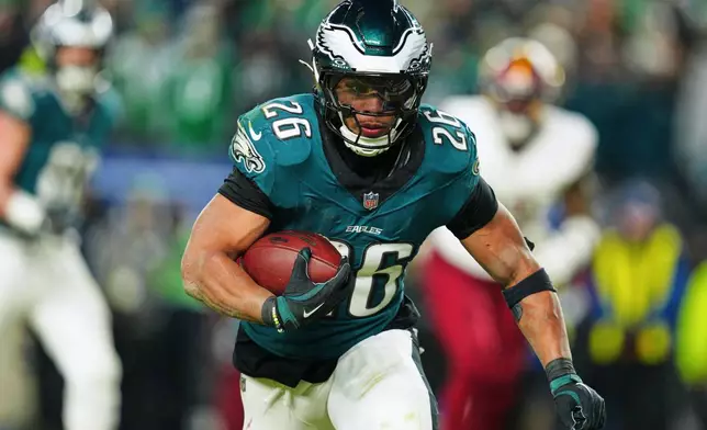FILE - Philadelphia Eagles running back Saquon Barkley (26) rushes for a touchdown against the Washington Commanders during the second half of the NFC Championship NFL football game, Sunday, Jan. 26, 2025, in Philadelphia. (AP Photo/Derik Hamilton, File)