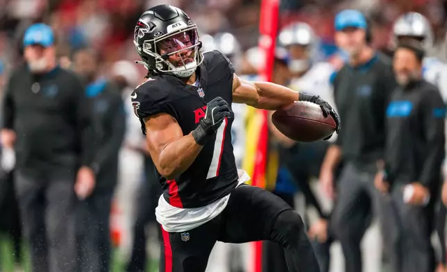 FILE - Atlanta Falcons running back Bijan Robinson (7) runs the ball during the first half of an NFL football game against the Carolina Panthers, Sunday, Jan. 5, 2025, in Atlanta. The Panthers defeated the Falcons 44-38. (AP Photo/Danny Karnik, File(
