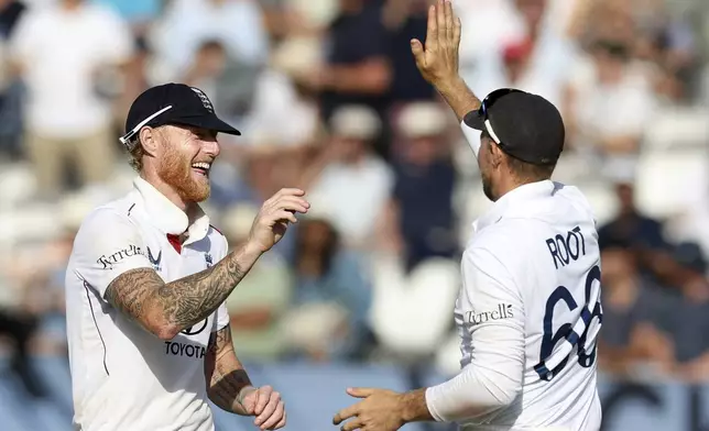 England's captain Ben Stokes, left, and England's Joe Root celebrate the dismissal of India's Jasprit Bumrah during the third cricket test match between England and India at Lord's cricket ground in London, Saturday, July 12, 2025. (AP Photo/Richard Pelham)