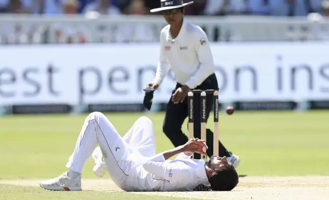 England's Shoaib Bashir falls down and injured when he tries to catch a ball during the third cricket test match between England and India at Lord's cricket ground in London, Saturday, July 12, 2025. (AP Photo/Richard Pelham)