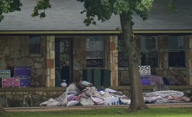 Bedding items are seen outside sleeping quarters at Camp Mystic along the banks of the Guadalupe River after a flash flood swept through the area Saturday, July 5, 2025, in Hunt, Texas. (AP Photo/Julio Cortez)