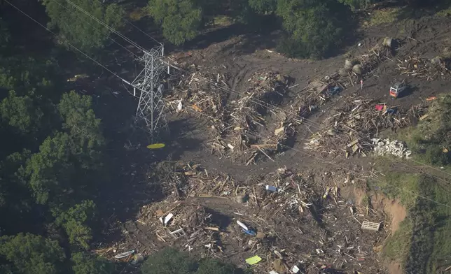 This aerial photo shows debris covering the ground in Hunt, Texas on Thursday, July 10, 2025. (AP Photo/Gerald Herbert)