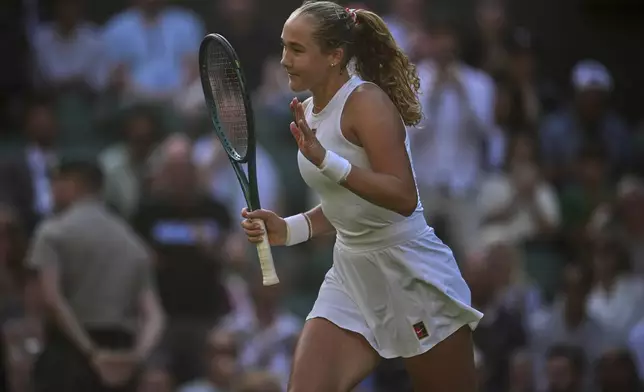 Mirra Andreeva of Russia celebrates after beating Emma Navarro of the U.S. during a fourth round women's singles match at the Wimbledon Tennis Championships in London, Monday, July 7, 2025. (AP Photo/Kin Cheung)