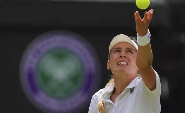 Ekaterina Alexandrova of Russia serves to Belinda Bencic of Switzerland during their women's singles fourth round match at the Wimbledon Tennis Championships in London, Monday, July 7, 2025.(AP Photo/Kirsty Wigglesworth)