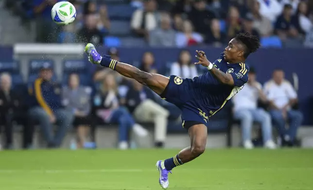 Vancouver Whitecaps defender Édier Ocampo kicks the ball during the first half of an MLS soccer match against the Los Angeles Galaxy, Friday, July 4, 2025, in Carson, Calif. (AP Photo/William Liang)