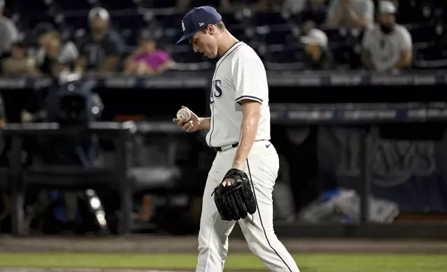 Tampa Bay Rays pitcher Kevin Kelly reacts after giving up an RBI single during the eighth inning of a baseball game against the Chicago White Sox Wednesday, July 23, 2025, in Tampa, Fla. (AP Photo/Jason Behnken)