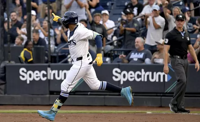 Tampa Bay Rays' Junior Caminero rounds the bases after his two-run home run during the first inning of a baseball game against the Chicago White Sox Wednesday, July 23, 2025, in Tampa, Fla. (AP Photo/Jason Behnken)