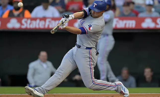 Texas Rangers' Corey Seager hits a two-run home run during the first inning of a baseball game against the Los Angeles Angels, Monday, July 7, 2025, in Anaheim, Calif. (AP Photo/Jayne Kamin-Oncea)
