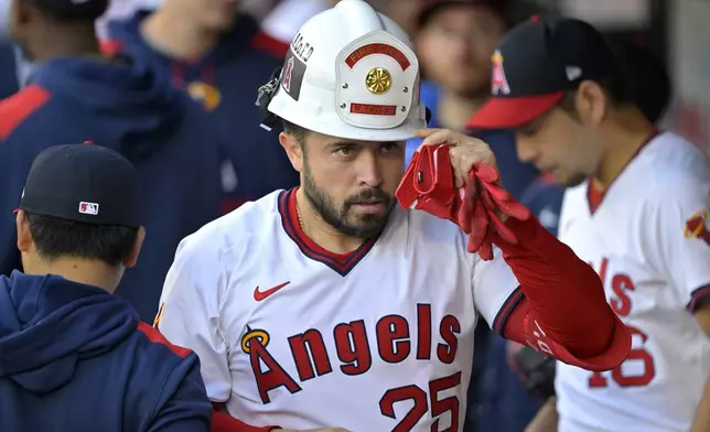 Los Angeles Angels' Travis d'Arnaud is congratulated in the dugout after hitting a two-run home run during the second inning of a baseball game against the Texas Rangers, Monday, July 7, 2025, in Anaheim, Calif. (AP Photo/Jayne Kamin-Oncea)