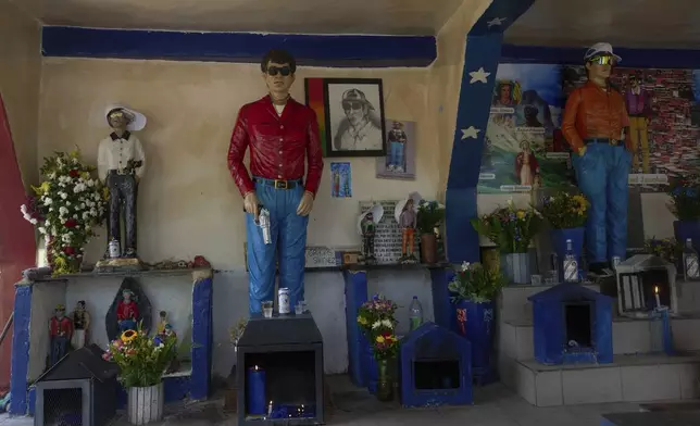 Statues of Ismael adorn the pantheon of "Santos Malandros," or Holy Thugs, in the historic "Cementerio General del Sur," or General Cemetery of the South, in Caracas, Venezuela, Sunday, July 6, 2025. (AP Photo/Ariana Cubillos)