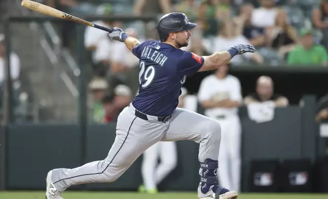 Seattle Mariners' Cal Raleigh hits a single that scores a run during the fifth inning of a baseball game against the Athletics, Monday, July 28, 2025, in West Sacramento, Calif. (AP Photo/Scott Marshall)