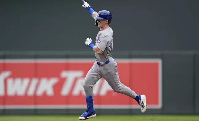 Chicago Cubs' Pete Crow-Armstrong points while running the bases after hitting a 2-run home run during the third inning of a baseball game against the Minnesota Twins Thursday, July 10, 2025, in Minneapolis. (AP Photo/Abbie Parr)