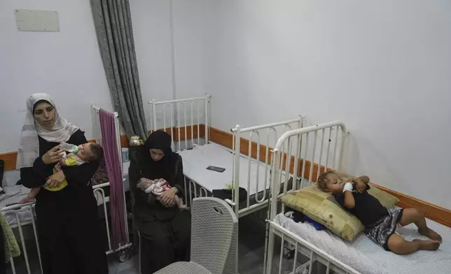 Palestinian women care for their malnourished babies at the Friends of the Patient Hospital in Gaza City on Wednesday, July 23, 2025. (AP Photo/Jehad Alshrafi)