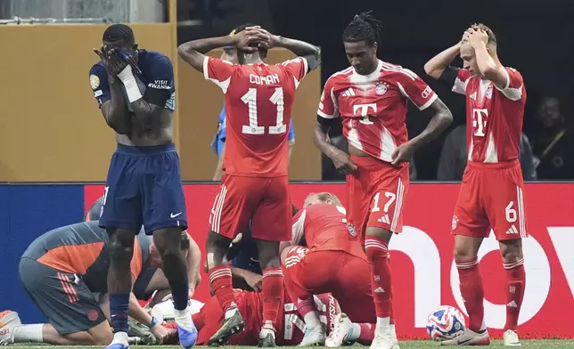 Bayern Munich's Jamal Musiala lies on the ground during the Club World Cup quarterfinal soccer match between PSG and Bayern Munich in Atlanta, Saturday, July 5, 2025. (AP Photo/Mike Stewart)