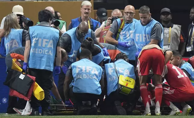 Bayern Munich's Jamal Musiala gets medical assistance during the Club World Cup quarterfinal soccer match between PSG and Bayern Munich in Atlanta, Saturday, July 5, 2025. (AP Photo/Mike Stewart)