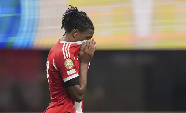 Bayern Munich's Michael Olise reacts to an injury to Bayern Munich's Jamal Musiala during the Club World Cup quarterfinal soccer match between PSG and Bayern Munich in Atlanta, Saturday, July 5, 2025. (AP Photo/Brynn Anderson)