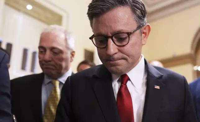 Speaker of the House Mike Johnson, R-La., with House Majority Leader Steve Scalise, R-La., left, walks to the chamber, at the Capitol in Washington, Wednesday, July 2, 2025. (AP Photo/J. Scott Applewhite)