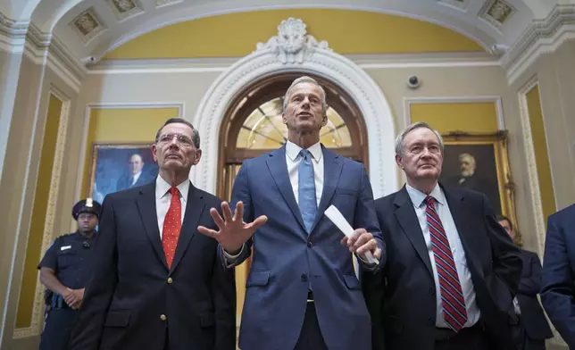 Senate Majority Leader John Thune, R-S.D., is flanked by Sen. John Barrasso, R-Wyo., the GOP whip, left, and Finance Committee Chairman Mike Crapo, R-Idaho, speaks to reporters after passage of the budget reconciliation package of President Donald Trump's signature bill of big tax breaks and spending cuts, at the Capitol in Washington, Tuesday, July 1, 2025. (AP Photo/J. Scott Applewhite)