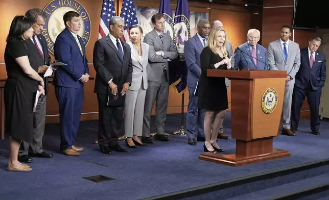 Rep. Madeleine Dean, D-Pa., center, speaks during a news conference at the U.S. Capitol, Wednesday, July 2, 2025, in Washington. (AP Photo/Mariam Zuhaib)