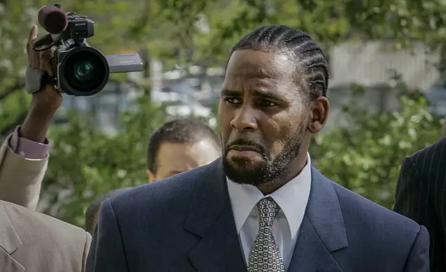 FILE - R. Kelly arrives for the first day of jury selection in his child pornography trial at the Cook County Criminal Courthouse in Chicago, May 9, 2008. (AP Photo/Charles Rex Arbogast, File)