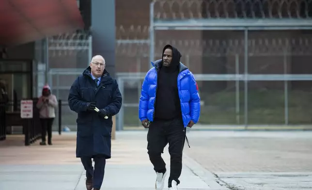 FILE - R. Kelly, right, walks out of Cook County Jail with his defense attorney, Steve Greenberg, after posting $100,000 bail, in Chicago, Feb. 25, 2019. R. Kelly is serving time at a prison in North Carolina. A federal appeals court upheld the Grammy Award-winning R&amp;B singer's 2021 racketeering and sex trafficking convictions, along with a 30-year prison sentence. (Ashlee Rezin/Chicago Sun-Times via AP File)
