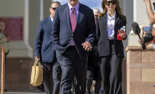 FILE - Actor Alec Baldwin and his wife Hilaria Baldwin leave District Court, July 10, 2024, following the day's proceedings in his involuntary manslaughter trial in Santa Fe, N.M. (AP Photo/Roberto E. Rosales, File)