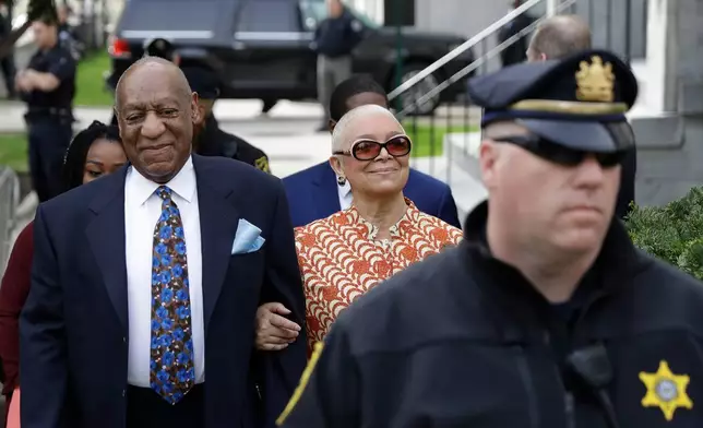 FILE - Bill Cosby, left, arrives with his wife, Camille, for his sexual assault trial, at the Montgomery County Courthouse in Norristown, Pa., April 24, 2018. (AP Photo/Matt Slocum, File)