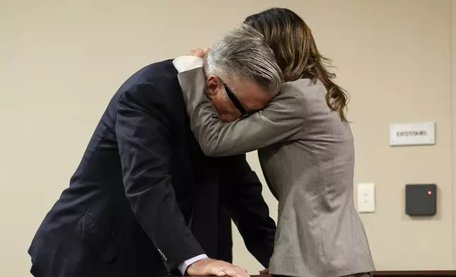 FILE - Hilaria Baldwin, right, speaks to her husband, actor Alec Baldwin, during his trial for involuntary manslaughter for the 2021 fatal shooting of cinematographer Halyna Hutchins during filming of the Western movie "Rust," July 12, 2024, at the County District Court in Santa Fe, N.M. (Ramsay de Give/Pool Photo via AP File)