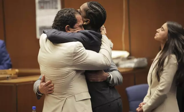 FILE - A$AP Rocky, center, is hugged by attorney Joe Tacopina after Rocky was found not guilty during his trial, Feb. 18, 2025, in Los Angeles. (Daniel Cole/Pool Photo via AP File)