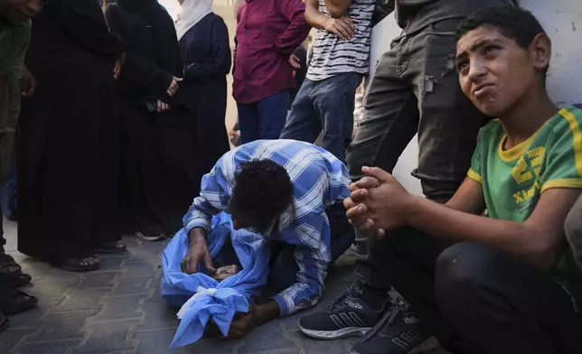 Mohammed Abu Qas mourns over the body of his sister Suad Abu Qas, 12, who was killed in an Israeli bombardment of Gaza Strip, at the Al-Awda Hospital in Nuseirat, on Tuesday, July 8, 2025. (AP Photo/Abdel Kareem Hana)