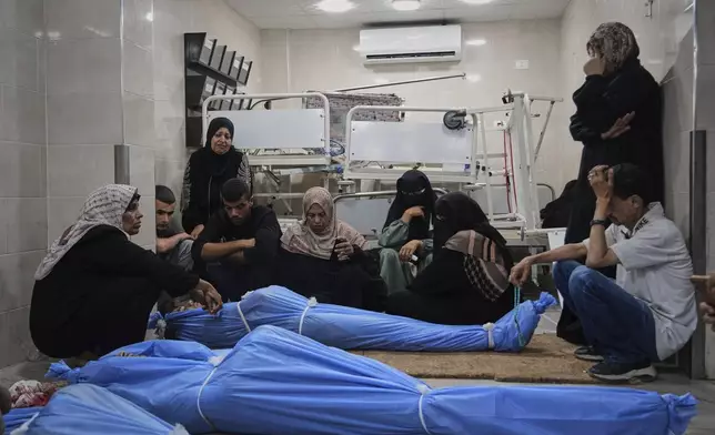 Mourners attend the funeral of victims who were killed in an Israeli bombardment of Gaza Strip, at the Al-Awda Hospital in Nuseirat, on Tuesday, July 8, 2025. (AP Photo/Abdel Kareem Hana)