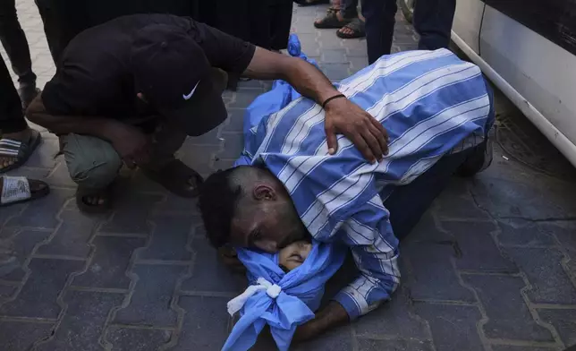 Mohammed Abu Qas mourns over the body of his sister Suad Abu Qas, 12, who was killed in an Israeli bombardment of Gaza Strip, at the Al-Awda Hospital in Nuseirat, on Tuesday, July 8, 2025. (AP Photo/Abdel Kareem Hana)