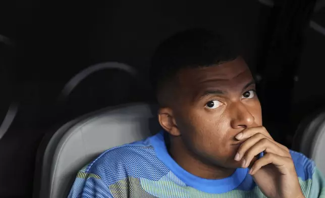 Real Madrid's Kylian Mbappe sits on the bench before the Club World Cup round of 16 soccer match between Real Madrid and Juventus in Miami Gardens, Fla., Tuesday, July 1, 2025. (AP Photo/Rebecca Blackwell)