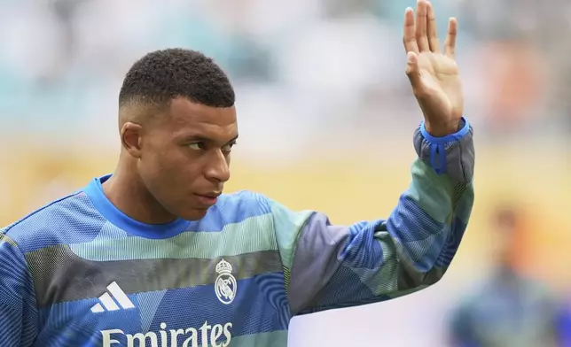 Real Madrid's Kylian Mbappe waves during a warmup for the Club World Cup round of 16 soccer match between Real Madrid and Juventus in Miami Gardens, Fla., Tuesday, July 1, 2025. (AP Photo/Rebecca Blackwell)